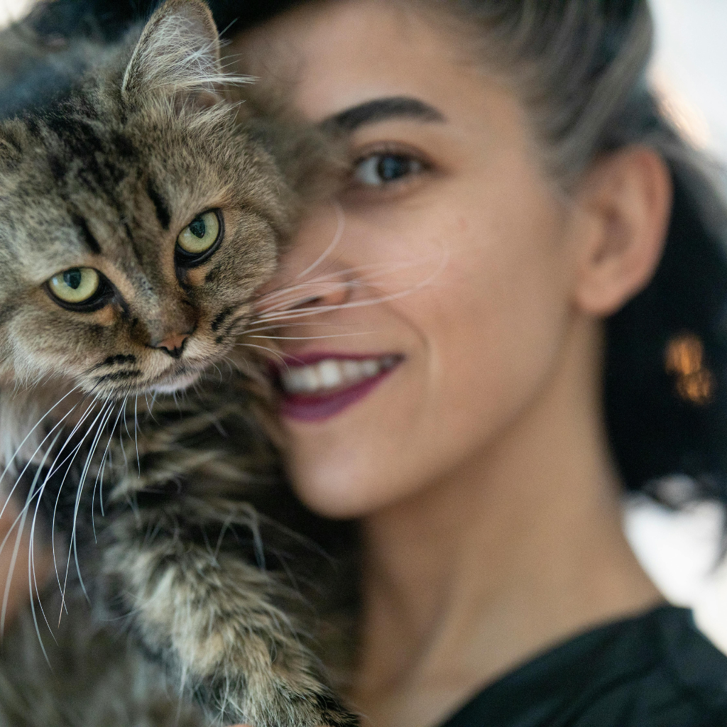 Mulher sorridente com gato Maine Coon no ombro satisfeita com produto Ferpa Design
